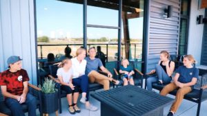 mast family enjoying the porch