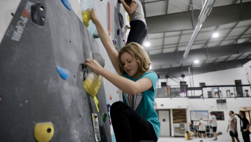 born family climbing on slab climb at alpine